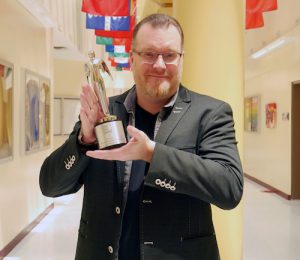 Thomas Seymour holds award